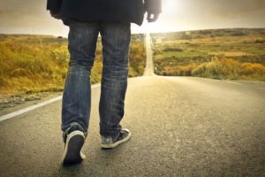 Man walking a long road